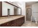 Bathroom featuring double vanity with granite countertops, a large mirror, and a glass-enclosed shower at 3245 Buckhead Forest Ne Mews, Atlanta, GA 30305