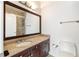 Bathroom with granite countertop vanity, dark wood cabinets, and tiled shower at 3245 Buckhead Forest Ne Mews, Atlanta, GA 30305