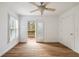 Bedroom featuring beautiful hardwood floors, a ceiling fan, and access to outdoor deck at 3245 Buckhead Forest Ne Mews, Atlanta, GA 30305