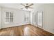 Empty bedroom with hardwood floors, ceiling fan, and access to an outdoor balcony at 3245 Buckhead Forest Ne Mews, Atlanta, GA 30305