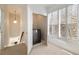Bright laundry area features a stackable washer/dryer and natural light from large windows at 3245 Buckhead Forest Ne Mews, Atlanta, GA 30305