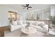 Bright living room features white sofa, hardwood floors and access to the kitchen area at 3245 Buckhead Forest Ne Mews, Atlanta, GA 30305