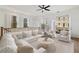 Bright living room features a white sectional sofa, area rug, and doors to an outdoor balcony at 3245 Buckhead Forest Ne Mews, Atlanta, GA 30305
