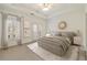Main bedroom with tray ceiling, a ceiling fan, and access to a balcony at 3245 Buckhead Forest Ne Mews, Atlanta, GA 30305