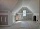 View of unfinished attic with window at 6851 Phillips Mill Rd, Douglasville, GA 30135