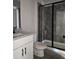 Bathroom featuring a tiled shower, commode and granite vanity at 6851 Phillips Mill Rd, Douglasville, GA 30135