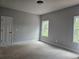 Unfinished bedroom with door and two windows at 6851 Phillips Mill Rd, Douglasville, GA 30135