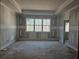Bedroom under construction, highlighting a tray ceiling and large windows at 6851 Phillips Mill Rd, Douglasville, GA 30135