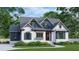 Two-story craftsman home with white brick, blue accents, and a landscaped lawn at 6851 Phillips Mill Rd, Douglasville, GA 30135