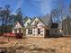New home construction featuring gray shingles, light siding, and a spacious layout in a wooded lot at 6851 Phillips Mill Rd, Douglasville, GA 30135