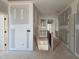 Hallway with doors and staircase with black metal railing at 6851 Phillips Mill Rd, Douglasville, GA 30135