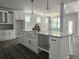 Modern kitchen with a large island, white cabinets, and stylish pendant lighting at 6851 Phillips Mill Rd, Douglasville, GA 30135