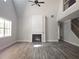 Spacious living room with a cozy fireplace, high ceilings, and modern flooring at 6851 Phillips Mill Rd, Douglasville, GA 30135