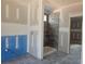 Unfinished primary bathroom showcasing a modern shower, tiled flooring, and rough-in plumbing at 6851 Phillips Mill Rd, Douglasville, GA 30135