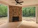 Outdoor patio with a stone fireplace and view of the woods at 6851 Phillips Mill Rd, Douglasville, GA 30135