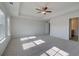 Main bedroom with carpeted floor, ceiling fan and access to bathroom at 249 Chiswick Loop, Stockbridge, GA 30281