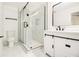 Elegant bathroom featuring a glass shower, modern vanity with matte black accents, and marble floors at 2736 Joyce Ave, Decatur, GA 30032