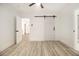 Spacious bedroom with hardwood floors and barn door at 2736 Joyce Ave, Decatur, GA 30032