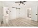 Spacious bedroom with hardwood floors and barn door at 2736 Joyce Ave, Decatur, GA 30032