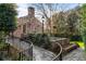 Charming brick home with manicured landscaping and a stone pathway leading to a patio at 3180 Arden Nw Rd, Atlanta, GA 30305