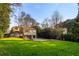 Expansive backyard with lush greenery and mature trees, offering privacy and space for outdoor activities at 3180 Arden Nw Rd, Atlanta, GA 30305