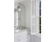 Elegant bathroom with marble countertop, arched mirror, and a window with shutters at 3180 Arden Nw Rd, Atlanta, GA 30305