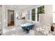 Bright bathroom featuring a clawfoot tub, marble countertops, and natural light from large windows at 3180 Arden Nw Rd, Atlanta, GA 30305