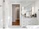 Bright bathroom featuring marble countertops, an expansive mirror, and access to a walk in closet at 3180 Arden Nw Rd, Atlanta, GA 30305