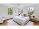 Stylish bedroom featuring a comfortable bed, modern decor, and natural light streaming through multiple windows at 3180 Arden Nw Rd, Atlanta, GA 30305