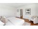 Bright bedroom features wood floors, closet with mirror door, and a comfortable accent chair at 3180 Arden Nw Rd, Atlanta, GA 30305