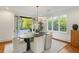 Bright dining room with modern light fixture, garden view and french doors to the backyard patio at 3180 Arden Nw Rd, Atlanta, GA 30305