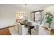 Dining room featuring a dark wood table, white chairs, and a view of the kitchen and outdoor patio at 3180 Arden Nw Rd, Atlanta, GA 30305