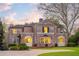 An elegant brick home with manicured landscaping, a circular driveway, and inviting curb appeal at 3180 Arden Nw Rd, Atlanta, GA 30305