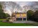 Charming two-story brick home featuring an attached two-car garage and a meticulously landscaped front yard at 3180 Arden Nw Rd, Atlanta, GA 30305