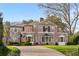 Charming brick home with a manicured lawn and a circular driveway that enhances the curb appeal at 3180 Arden Nw Rd, Atlanta, GA 30305