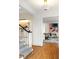 Bright foyer featuring hardwood floors, stairs with patterned carpet and an open view of the living room at 3180 Arden Nw Rd, Atlanta, GA 30305