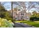 Lovely red brick home with manicured landscaping and mature trees surrounding the property at 3180 Arden Nw Rd, Atlanta, GA 30305