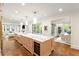 Expansive kitchen island with marble countertops, wine fridge and seamless flow to living area at 3180 Arden Nw Rd, Atlanta, GA 30305