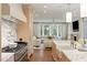 Open-concept kitchen boasts marble countertops, stainless steel appliances, and seamless flow to living area at 3180 Arden Nw Rd, Atlanta, GA 30305