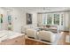 Sunlit living room with hardwood floors, neutral furniture, and large windows overlooking greenery at 3180 Arden Nw Rd, Atlanta, GA 30305