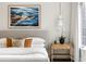 Bright main bedroom featuring a wooden nightstand, an oversized picture and an elegant bedside lamp at 3180 Arden Nw Rd, Atlanta, GA 30305