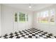 Sunroom with a black and white checkered floor, multiple windows, and a bright, airy atmosphere at 3180 Arden Nw Rd, Atlanta, GA 30305