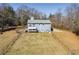 Aerial view of house, showcasing backyard and surrounding trees at 446 Mcgukin Rd, Bremen, GA 30110