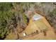 Aerial view of house and surrounding land, showing fence and outbuildings at 446 Mcgukin Rd, Bremen, GA 30110