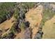 Aerial view showcasing property's large land and surrounding woods at 446 Mcgukin Rd, Bremen, GA 30110