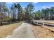 Long driveway with white fence leading to property at 446 Mcgukin Rd, Bremen, GA 30110