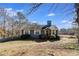 A cozy single-Gathering home with a charming exterior, surrounded by trees and a well-manicured lawn on a clear day at 446 Mcgukin Rd, Bremen, GA 30110