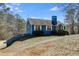 Charming single-story home with blue siding, white trim, and a neatly landscaped front yard on a sunny day at 446 Mcgukin Rd, Bremen, GA 30110