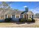 Attractive blue home with white-framed windows and a charming front entrance surrounded by lush green bushes at 446 Mcgukin Rd, Bremen, GA 30110