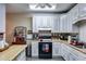 Kitchen with white cabinets, wood countertops, and appliances at 446 Mcgukin Rd, Bremen, GA 30110